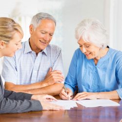 Older couple signing a document