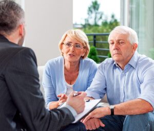 Older couple speaking with a lawyer