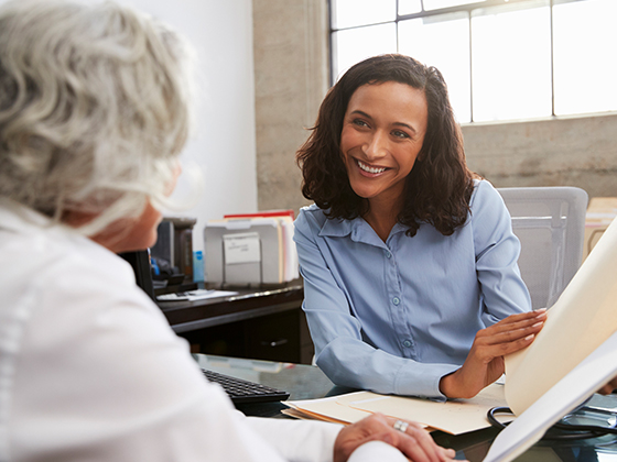 Patient advocate reviews a mesothelioma guide with an older woman