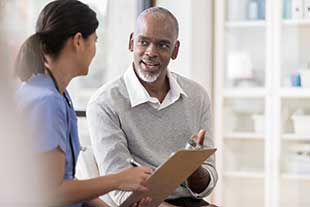 man speaking with doctor about treatment plan