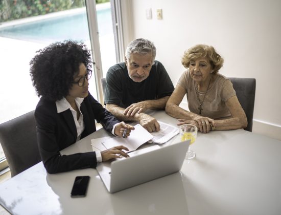 Older couple meeting with a lawyer in their home