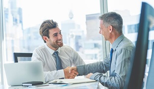 Two men shaking hands in an office